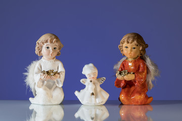 Closeup of three angels made of porcelain