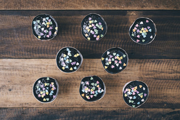 homemade cupcakes on a wooden table (top view)