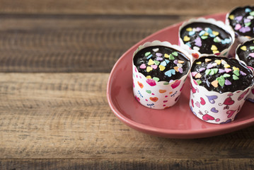homemade cupcakes in plate on a wooden table