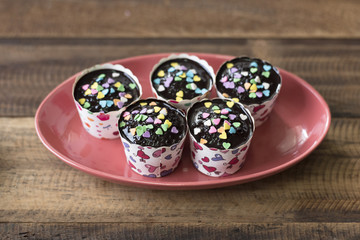 homemade cupcakes in plate on a wooden table