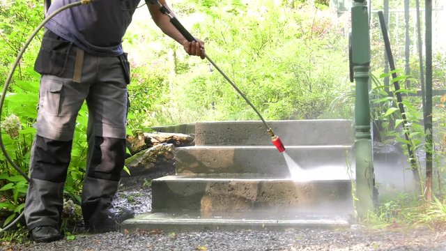 industrial pressure washing concrete steps 4k slow motion medium view