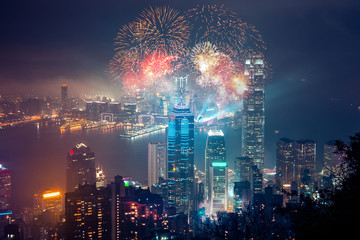 Double exposure of fireworks and Hong Kong city