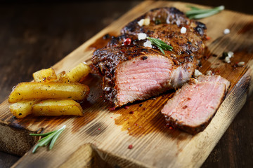 grilled juicy steak with rosemary.