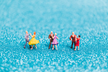 Miniature people , Couple dancing on blue glitter background , Valentine's day concept