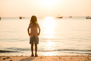 travel background girl stand alone on beach looking beautiful sea sunset. image for person, nature, portrait, landscape, scenery, evening concept