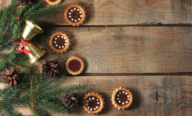 Christmas background with spruce branches and cones with cookies