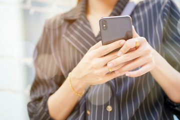 close up businesswoman hand using smartphone for checking email or working with partner at outdoor office , business concept