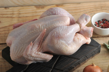 whole raw chicken carcass with associated twine feet