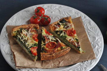 French quiche with eggs, fresh spinach, tomatoes, bacon