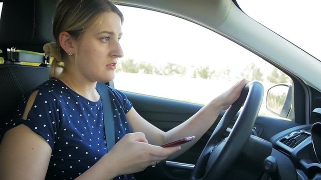 Slow motion footage of young female driver got in car accident while driving and using smartphone