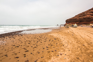 Coast, wave, beach and a large rock