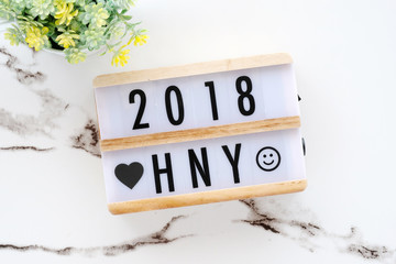 2018 happy new year on wood box on white marble table background, 2018 new year greeting card banner