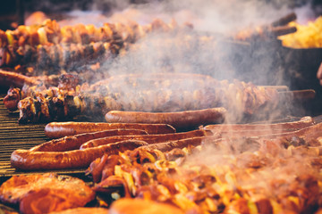 Meat skewers and sausages barbecued on a grill at  Krakow's Christmas market.