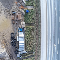 Aerial view of the material store for canal construction work on the construction site of a new development area