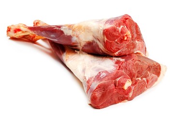 Fresh raw meat of a leg young lamb on white background 