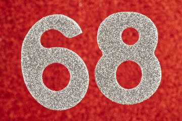 Number sixty-eight silver color over a red background. Anniversary
