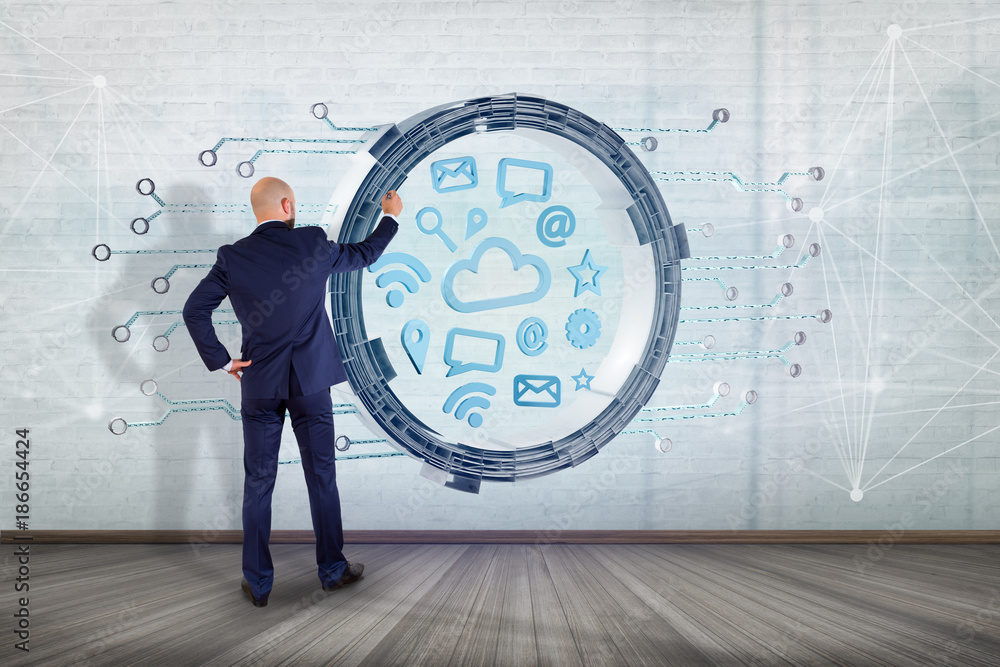 Poster businessman in front of a wall with cloud symbol connection surrounded by multimedia and internet ap