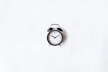 White office desk table with alarm clock. Top view with copy space, flat lay.