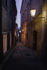 Fototapeta na wymiar Night street of old city. Vintage lanterns and old buildings