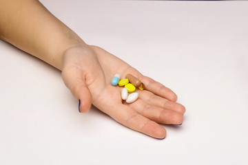 Medical pills in the hand isolated white background.