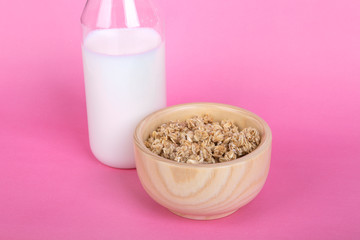 Healthy Breakfast with Muesli Cereal in Bowl and Milk in Bottle
