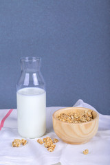 Healthy Breakfast with Muesli Cereal in Bowl and Milk in Bottle