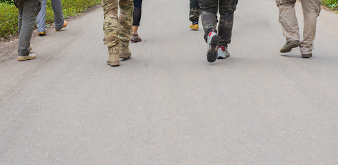 A group of tourists are walking on the concrete road to head to