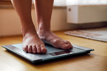 Female bare feet on the digital scale