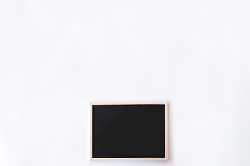 White office desk table with chalkboard. Top view with copy space, flat lay.