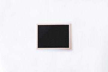 White office desk table with chalkboard. Top view with copy space, flat lay.