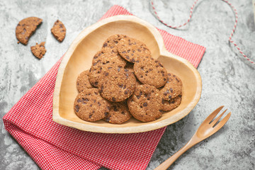 Traditional chocolate chip cookies on heart shape plate.