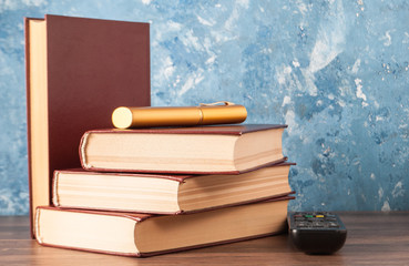 Books, a case from glasses and a remote control