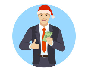 Businessman in Santa hat showing thumb up with cash money