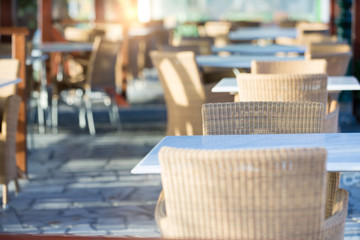 Tables and chairs in a street restaurant in Kamari on Santorini