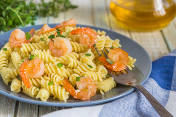 Italian pasta fusilli with shrimps and thyme