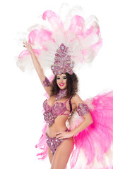 Fototapeta premium cheerful woman posing in carnival costume with pink feathers, isolated on white