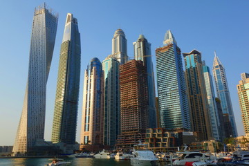 Plakat Panoramic view with modern skyscrapers and water pier of Dubai Marina at sunset, United Arab Emirates