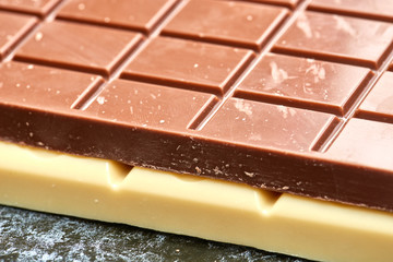 black chocolate lies on the white on table chocolate closeup