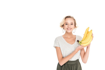 Obraz premium beautiful young woman holding fresh ripe bananas and smiling at camera isolated on white