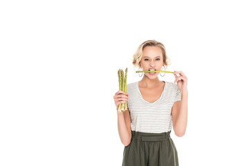 Fototapeta na wymiar portrait of young woman biting raw asparagus in hands isolated on white