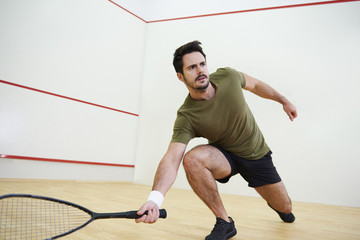 Man during squash match on court.