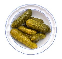 Marinated pickled cucumbers isolated in plate on white