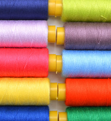 Sewing threads multicolored background closeup