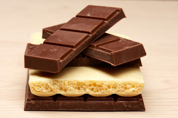 stack of four black and one white chocolate closeup
