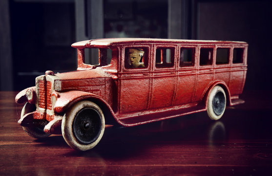 red vintage toy truck  on dark wooden table