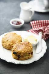 Fototapeta na wymiar Fresh homemade scones with butter and jam