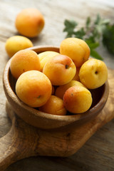 Fresh apricots in wooden bowl