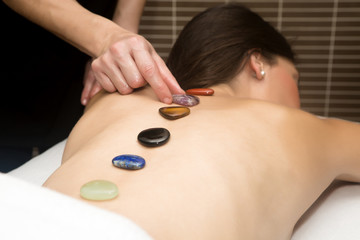 Handsome woman getting massage with hot stones