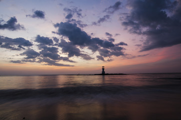 Fototapeta na wymiar sunset on the beach and light house