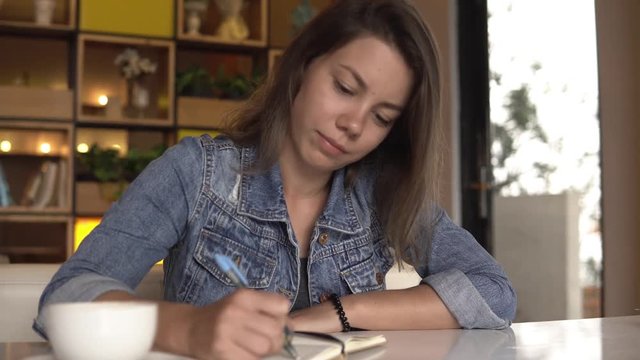 Woman is writing in diary